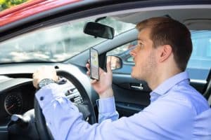 The driver nearly caused an accident while using their phone behind the wheel.