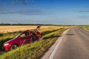 The red car accident was caused by the dangerous cuts in the road.