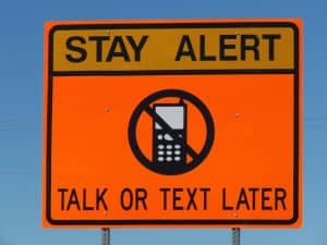 traffic sign: Stay Alert, Talk or Text Later