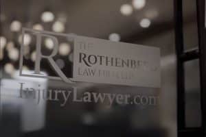 The Rothenberg Law Firm Accident and Injury Lawyers logo on glass